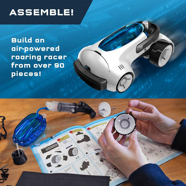 Children's toy assembly kit with an air-powered racer, building materials, and instructions on a wooden surface.