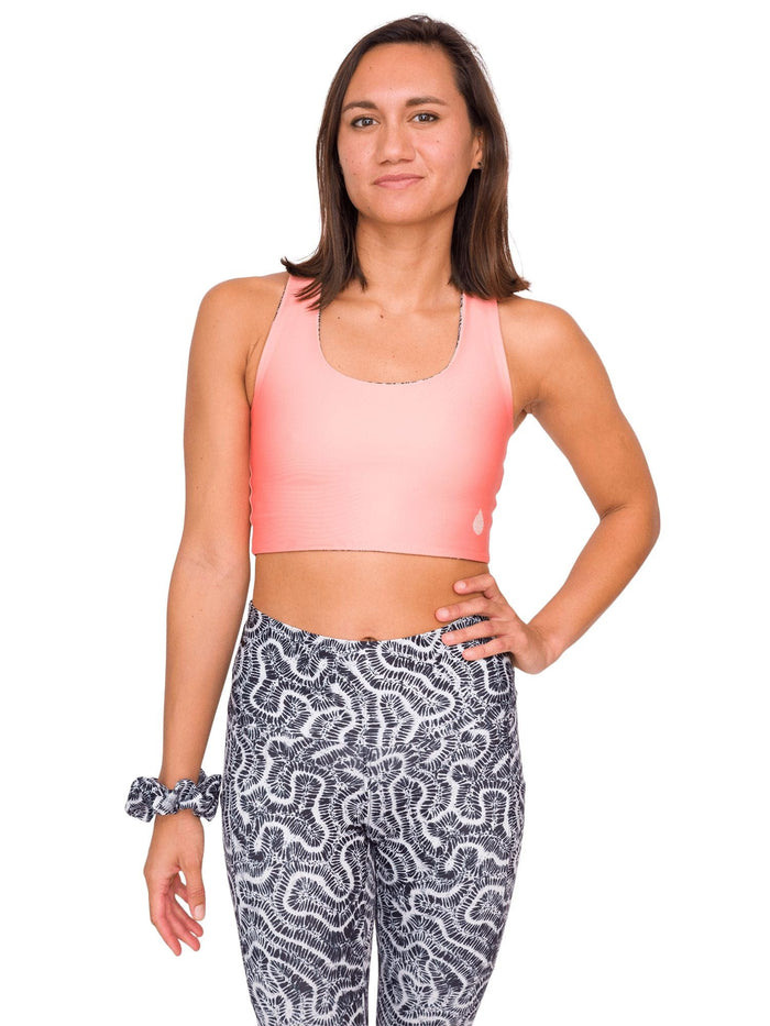 Model: Remedy is an avid freediver, Olympian, and coral restoration scientist. She is 5'7", 130lbs, and is wearing a size S Reversible Top and XS Legging.