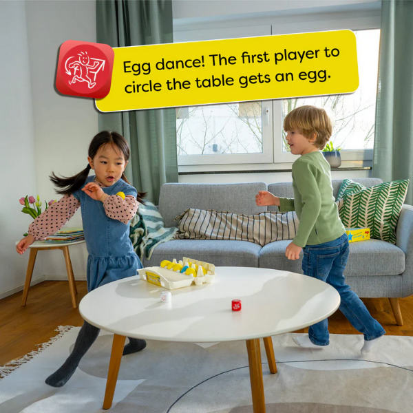 Two children playing a game around a table with an egg on top, in a living room setting.