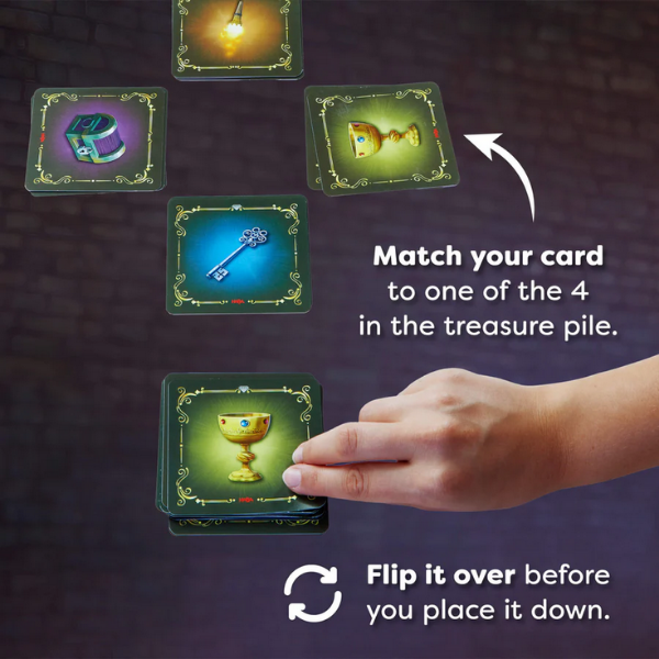 Card game instructions with cards and a hand on a dark background