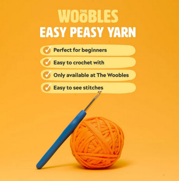 Orange ball of yarn with a blue crochet hook featuring text about 'The Woobles Easy Peasy Yarn'.