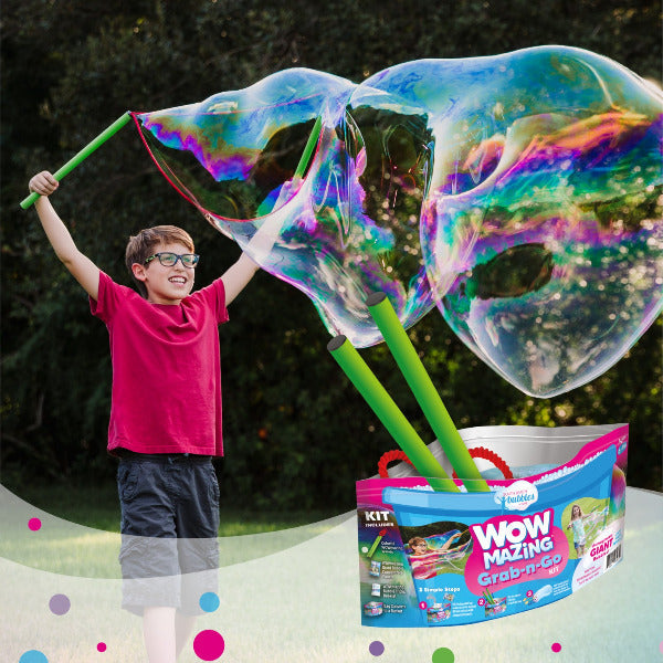 Child holding giant bubbles with a bubble kit labeled 'Wow Mazing Grab-n-Go' in the foreground.