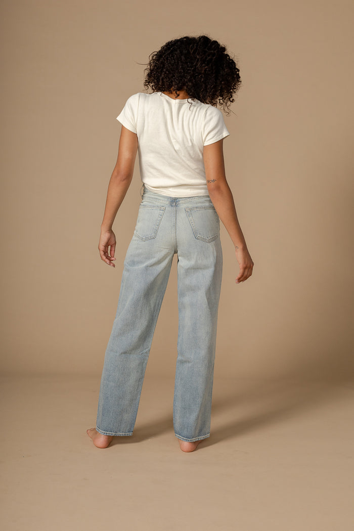 EDWIN USA relaxed barrel jeans for women in light blue denim worn by model from back
