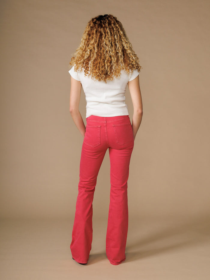 EDWIN high quality bootcut jeans for women in red worn by a model with curly hair and white top
