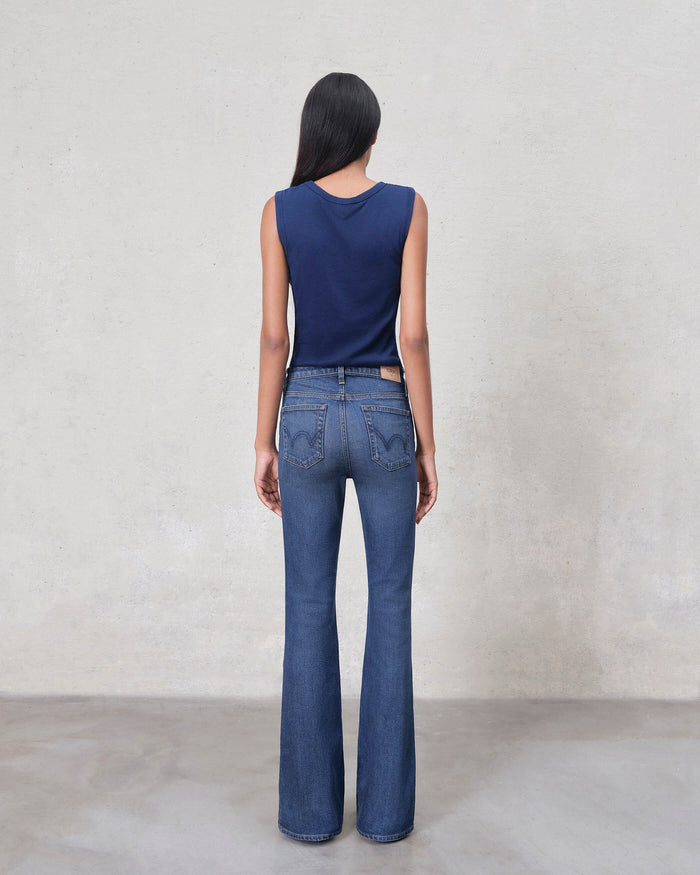 EDWIN back view of model wearing premium bootcut denim jeans in dark blue with high waist and rear pockets
