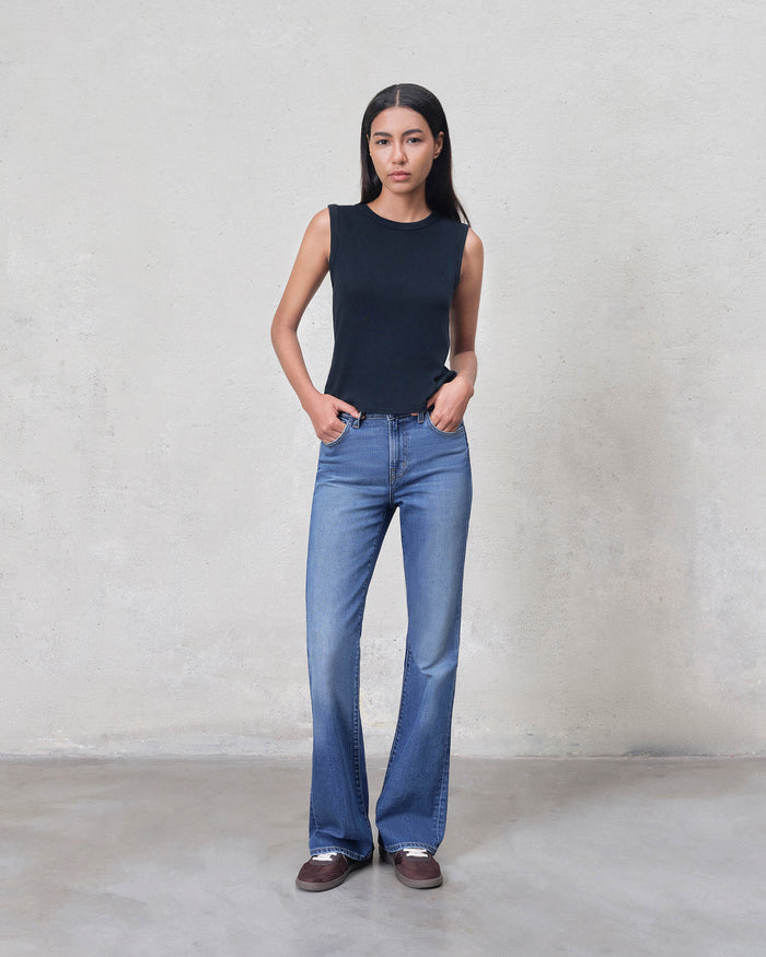 EDWIN high-quality US-made bootcut jeans on model in mid blue wash with slim waist and flared legs