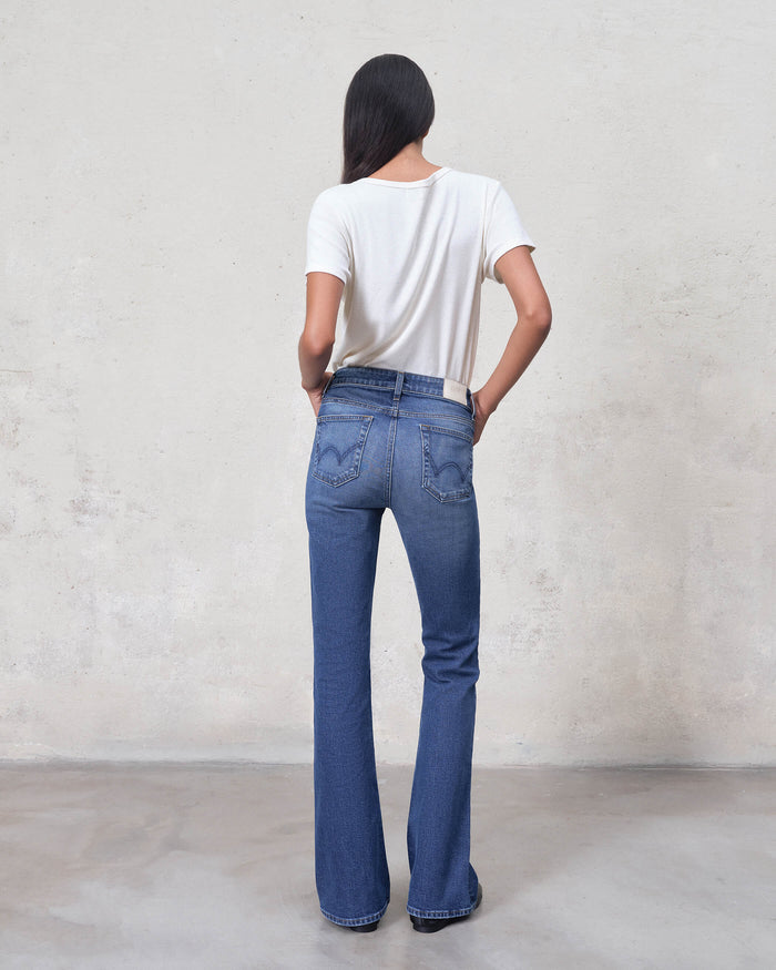 EDWIN women's bootcut jeans made in USA back view medium blue wash high rise flared leg model wearing white tee