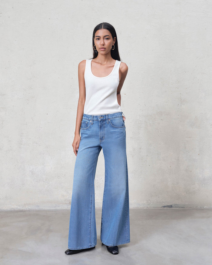 EDWIN light wash super wide leg jeans women on model wearing white tank top full length denim
