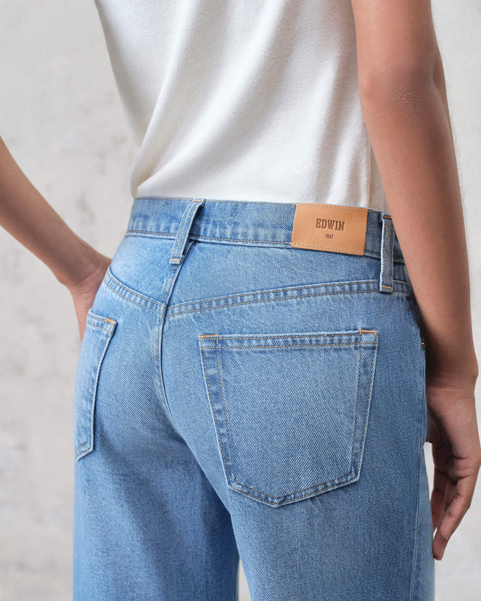 EDWIN light wash denim super wide leg jeans women shown from back with high waist and leather brand patch