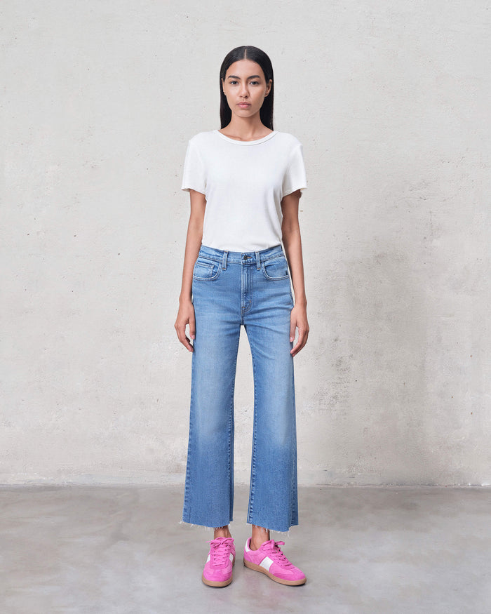 EDWIN women's premium cropped wide leg jeans light wash on model paired with white tee and pink sneakers