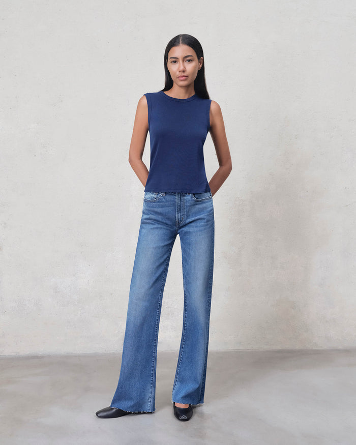 EDWIN wide leg raw hem jeans for women shown on model with navy sleeveless top mid rise light wash denim