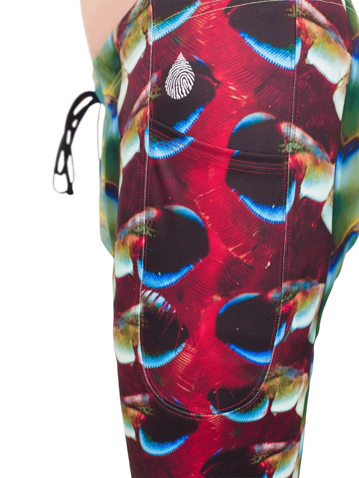 Close up side view of the side leg pocket on the men's mantis shrimp legging showing the vibrant colorful printing.