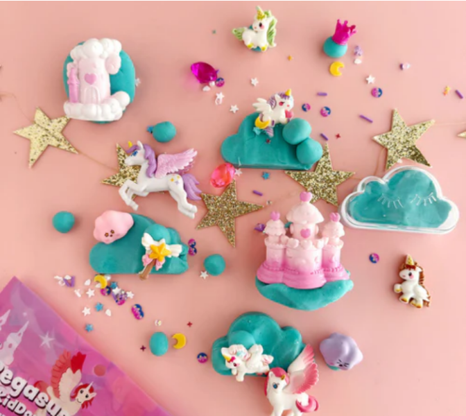 Colorful unicorn-themed play dough figures on a pink background
