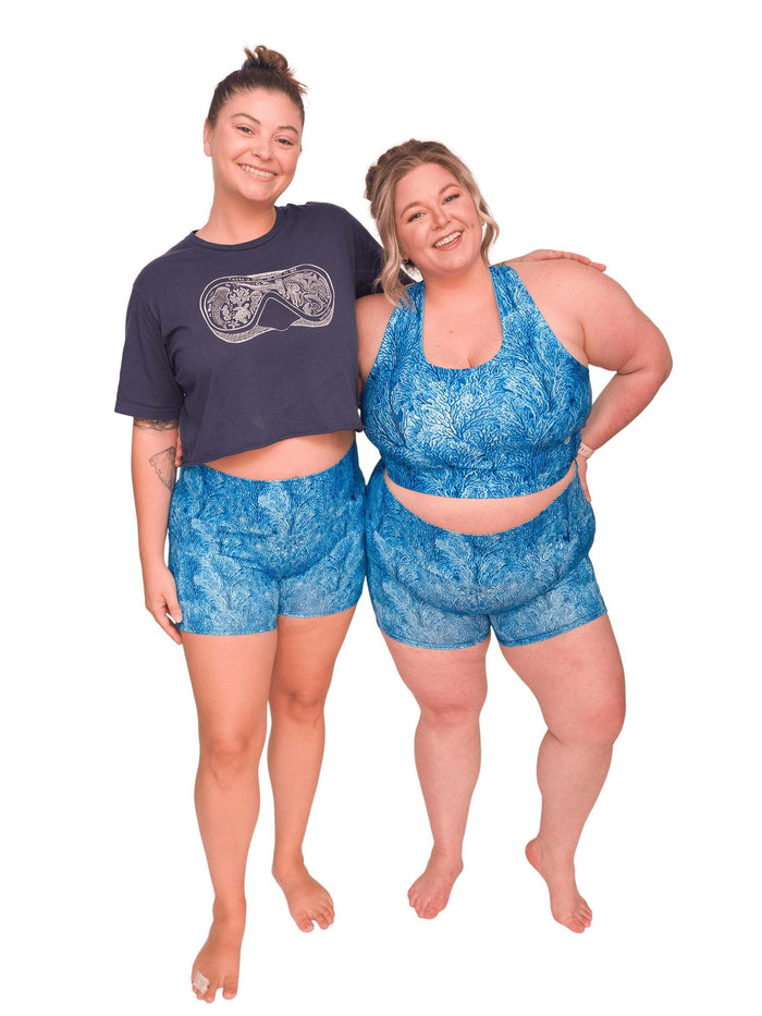 Model: Camilla (Left) is 5'8", 190 lbs, a 36C, and wearing an XL shorts and L tee. Chelsea (Right) is 5'2", 230 lbs, 40DD and is wearing 3XL shorts and a 3XL reversible top.