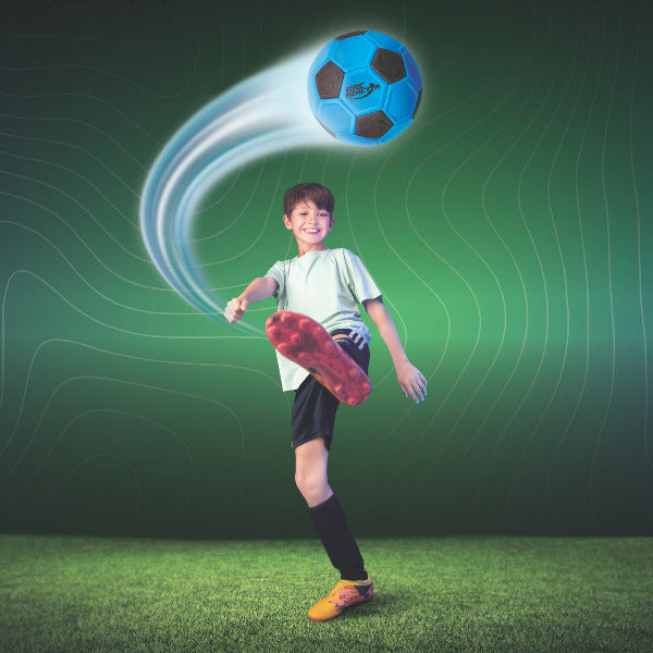 Child kicking a soccer ball with a dynamic background