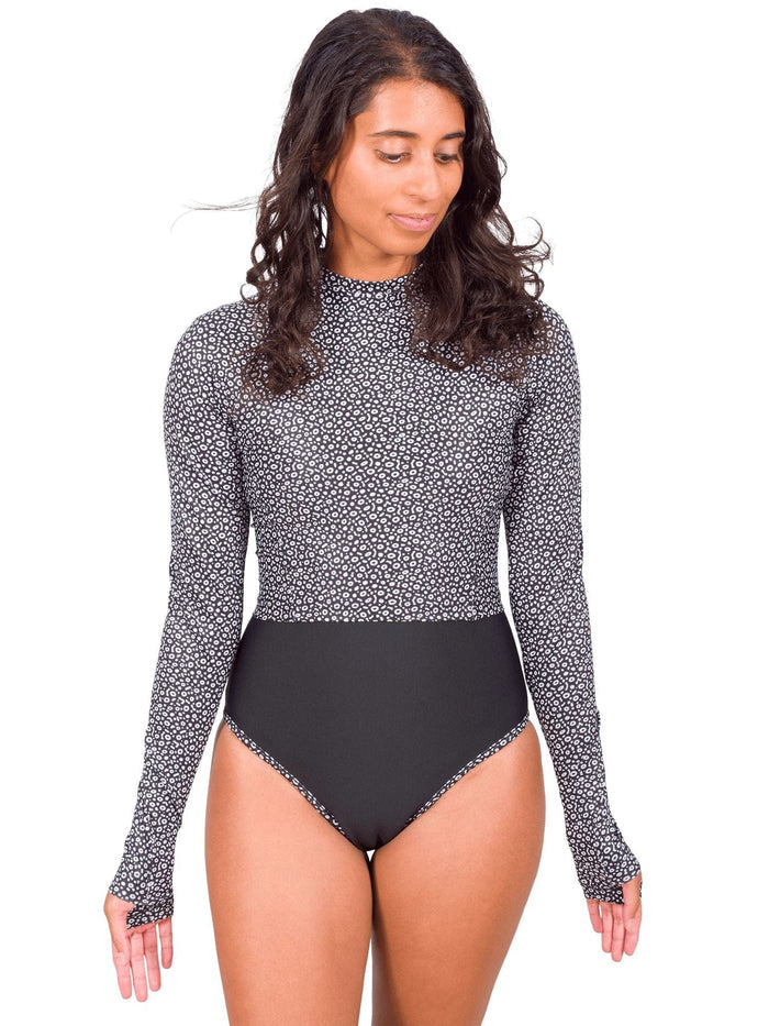 Model: Michelle is a marine science educator, coral reef ecologist, and scientific diver. She is 5'3", 111lbs, 32A and is wearing a size XS One-Piece Swimsuit with a S Cropped Rashgaurd on top.