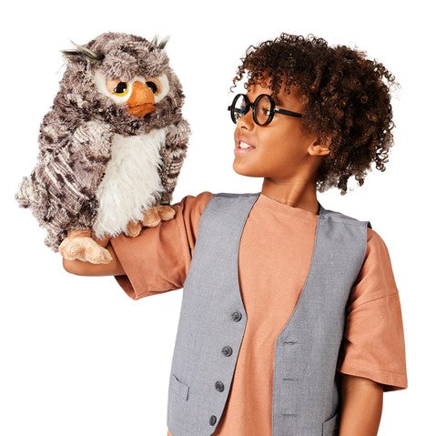 Child puppeteering wise owl puppet