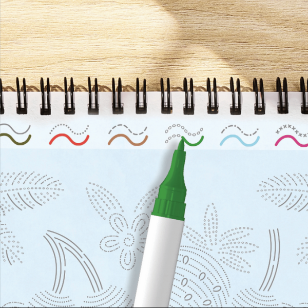 Green marker on a notebook with decorative patterns